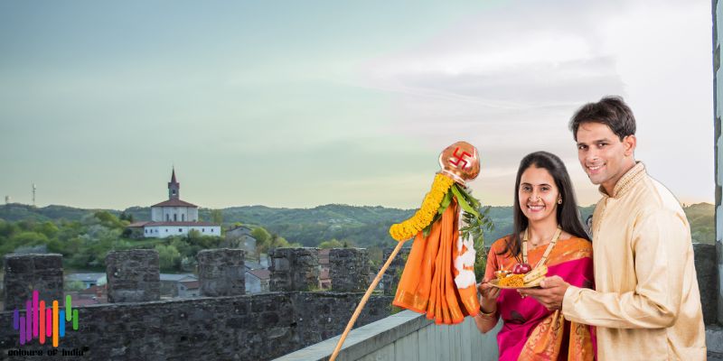 Woman decorating traditional Gudi with flowers and neem